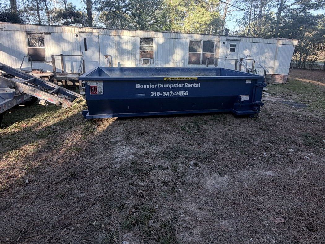 Blue Bossier Dumpster Rental container set for a property clean-out near Benton